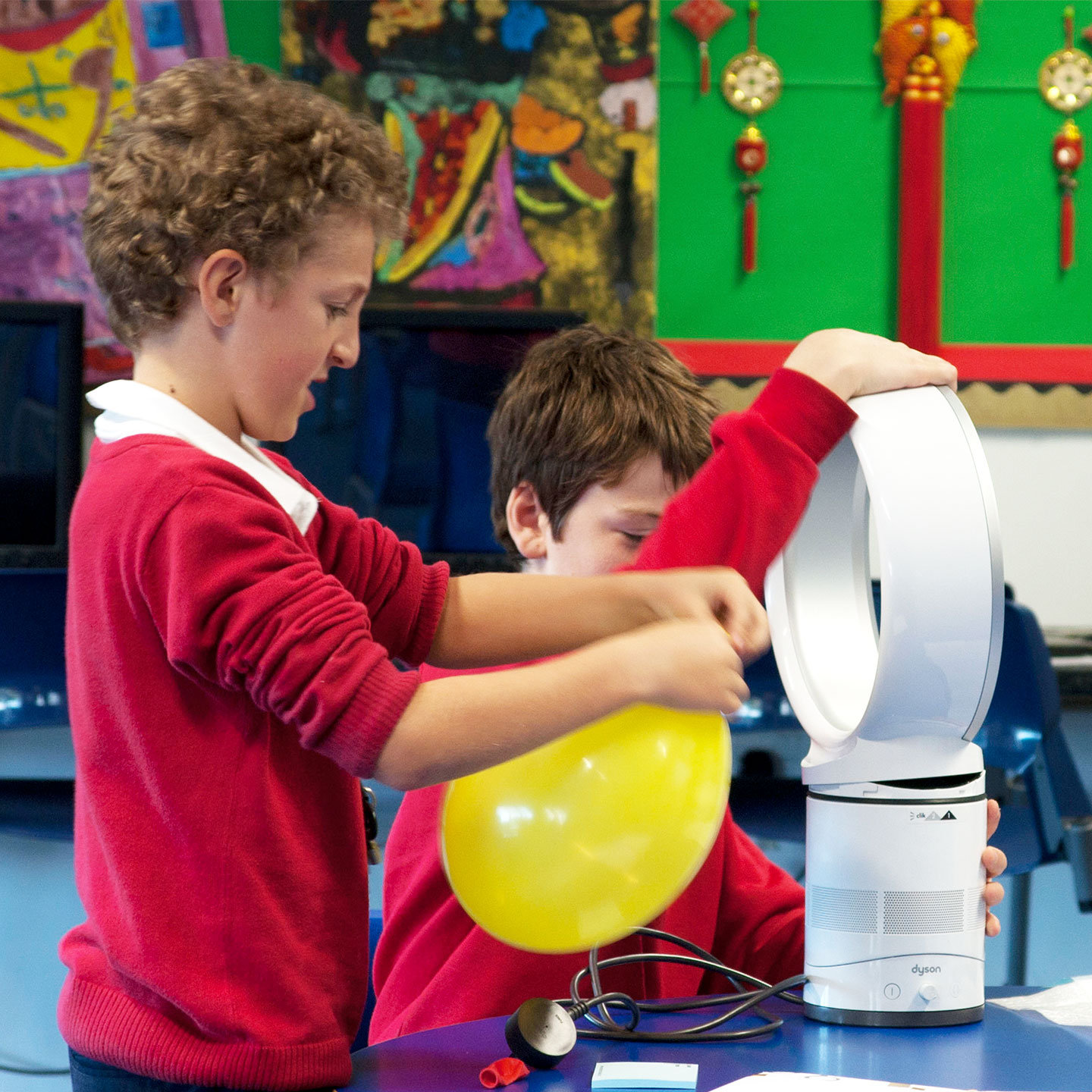 Primary school students taking part in a lesson from the Design Process Box using the Dyson Air Multiplier fan.