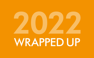 Orange background with '2022' written in lighter orange writing and 'wrapped up' written in white writing.