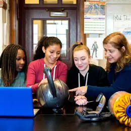 Three students and a teacher conducting a product analysis.