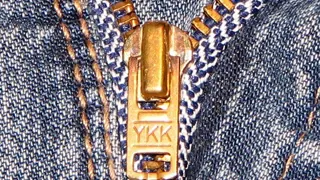 A close-up of a zip on denim.