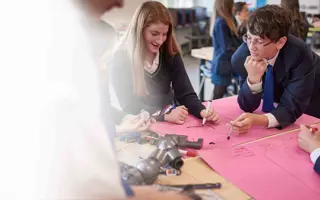 A group of students sketching their inventions in a prototyping workshop.