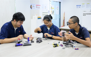 Students disassembling vacuum heads with the launch of the Engineering Box in Singapore.