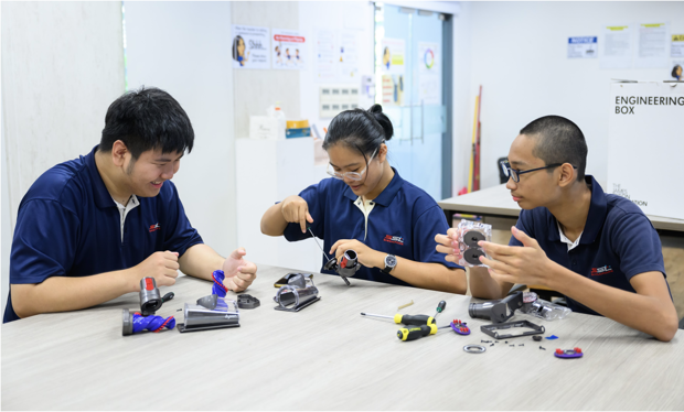 Students disassembling vacuum heads with the launch of the Engineering Box in Singapore.