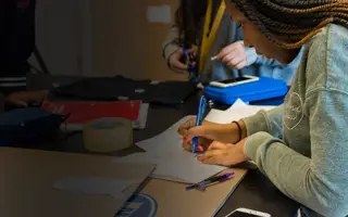 A student sketching ideas for an invention.