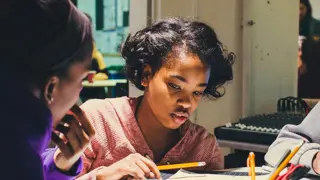 A student sketching ideas for an invention.