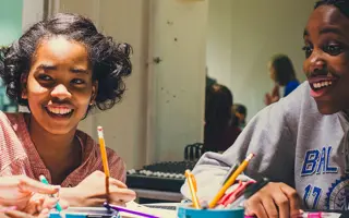 Two female students drawing prototypes.