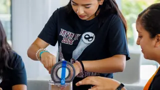 A student building a prototype from cardboard and Dyson machine parts